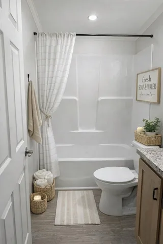 a bathroom with a toilet and a shower
