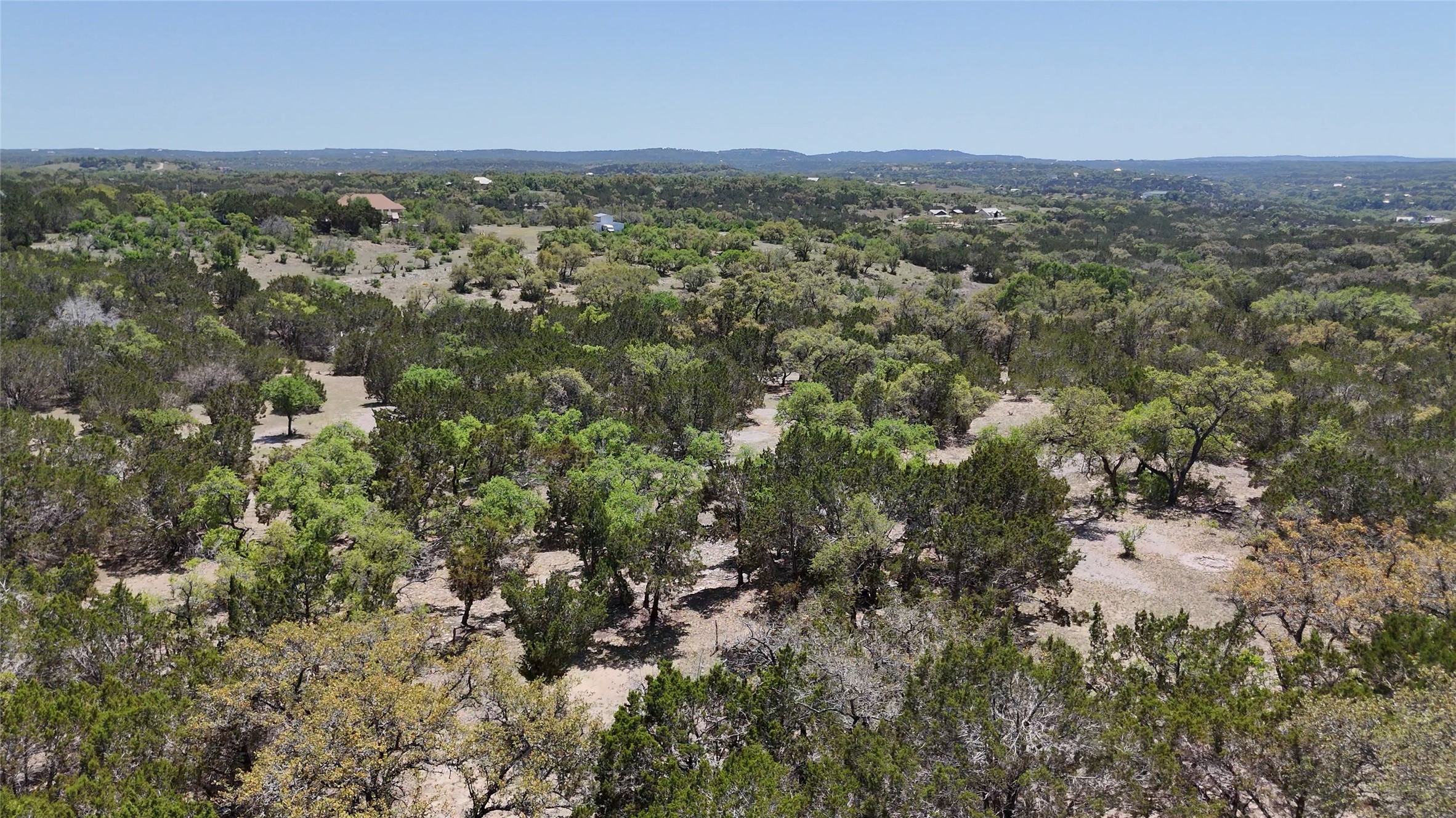 8201 West Fitzhugh Road Dripping Springs, TX 78620 - Photo 3 of 9 an aerial view of residential houses with outdoor space and trees