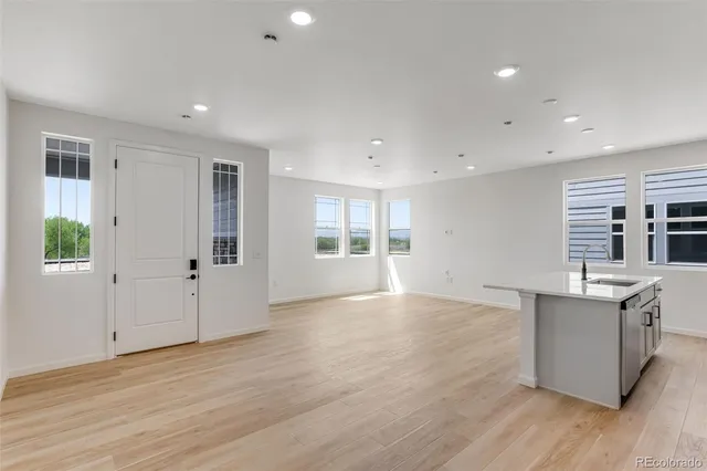 an empty room with windows and closet