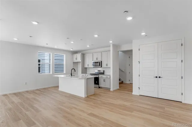 a view of a room with wooden floor