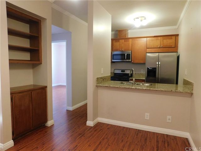 a kitchen with a refrigerator and a stove top oven