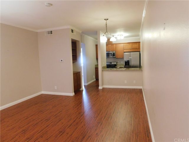 a view of a kitchen with a sink and wooden floor