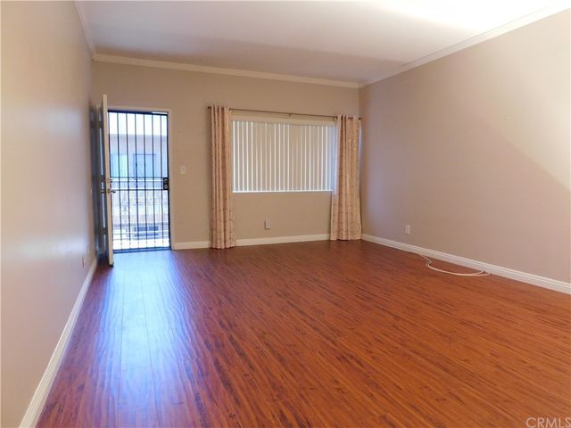 a view of a kitchen with a sink and a refrigerator