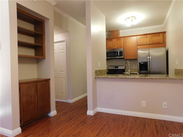 a kitchen with a sink a microwave and cabinets