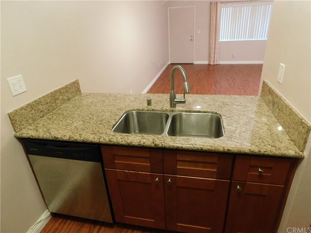 a view of a kitchen from a hallway