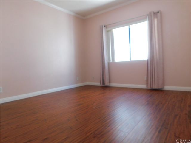 an empty room with wooden floor and closet
