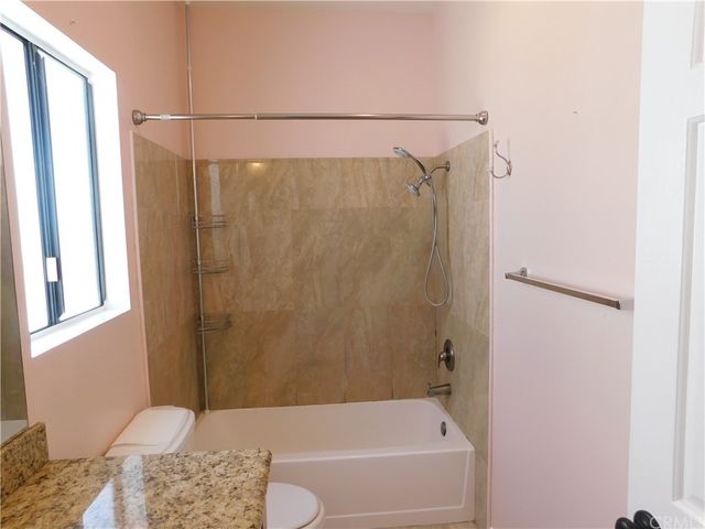 a bathroom with a shower and a toilet