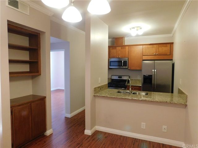 a kitchen with a refrigerator and a sink