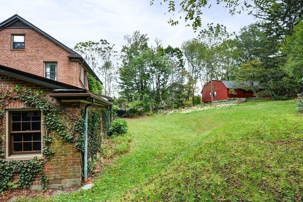 85 Forbes Road Milton, MA 02186 - Photo 23 of 30 a view of a house with a yard and sitting area