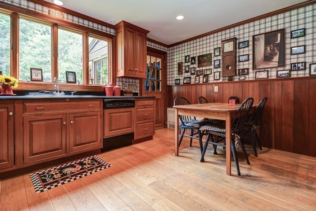85 Forbes Road Milton, MA 02186 - Photo 4 of 30 a open kitchen with stainless steel appliances granite countertop a stove top oven a sink dishwasher and cabinets with wooden floor