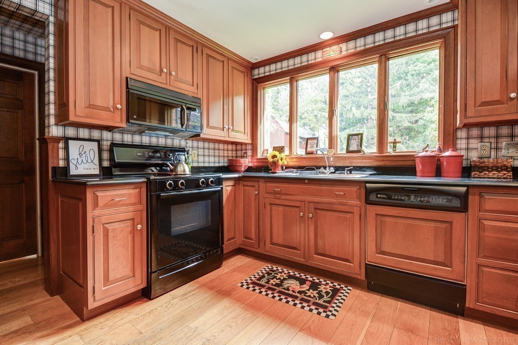 85 Forbes Road Milton, MA 02186 - Photo 5 of 30 a kitchen with stainless steel appliances granite countertop a stove a sink and a microwave