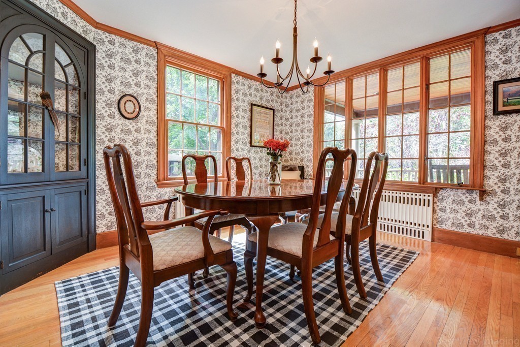 85 Forbes Road Milton, MA 02186 - Photo 7 of 30 a view of a dining room with furniture wooden floor and chandelier