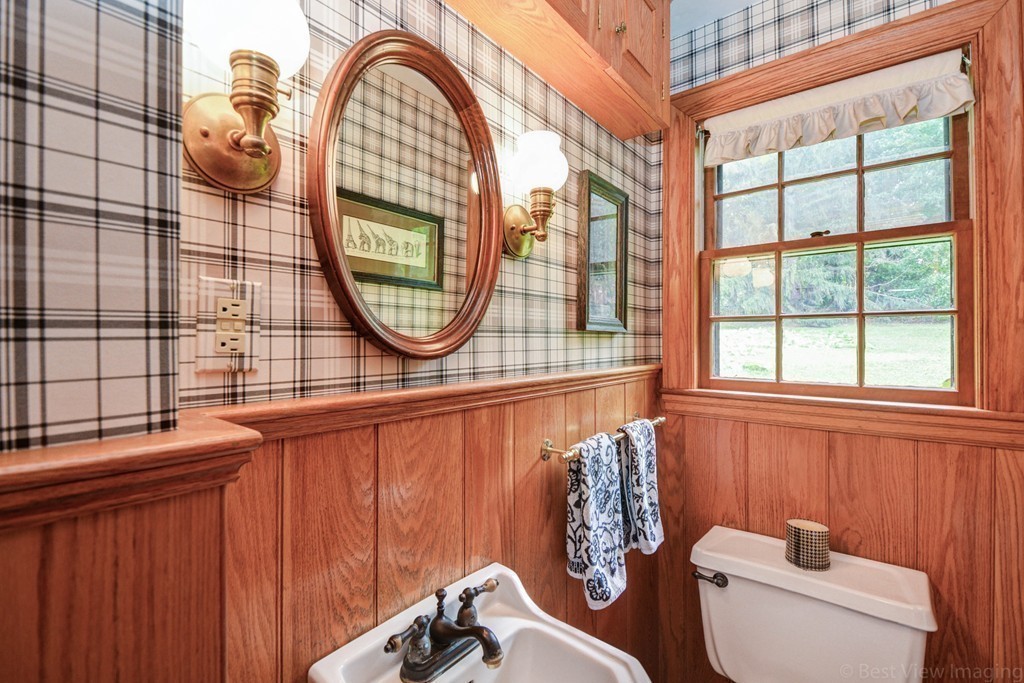 85 Forbes Road Milton, MA 02186 - Photo 9 of 30 a bathroom with a toilet a sink and a window