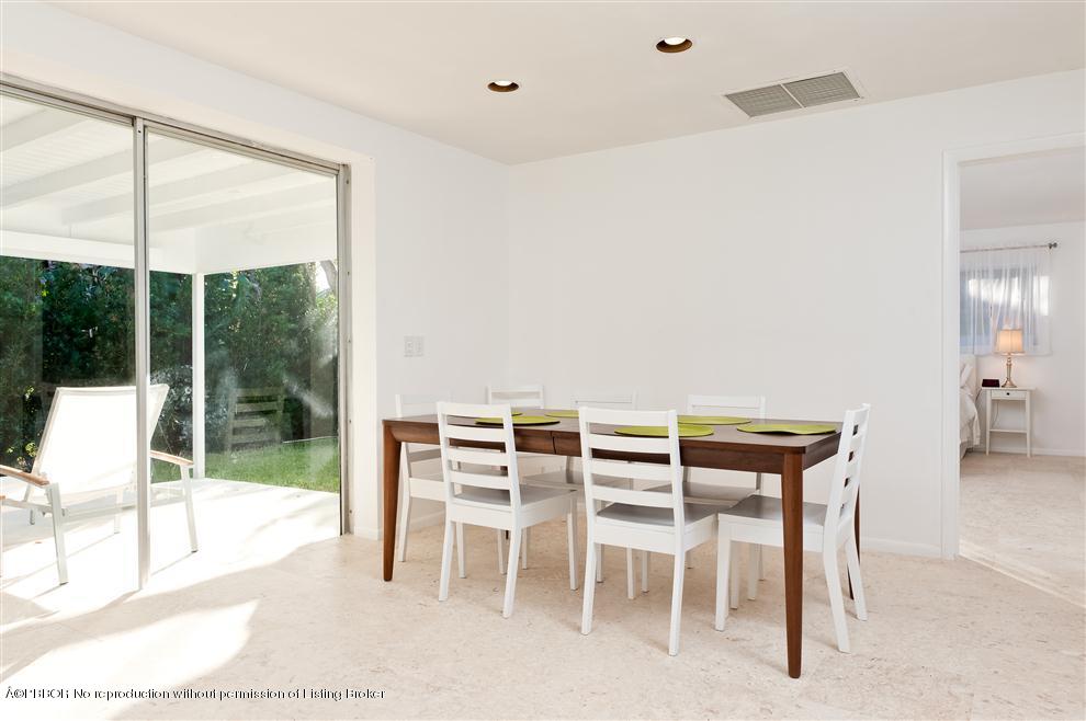 110 Seagate Road Palm Beach, FL 33480 - Photo 3 of 14 a dining room with furniture and a floor to ceiling window