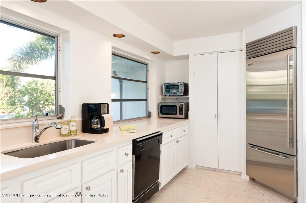 110 Seagate Road Palm Beach, FL 33480 - Photo 4 of 14 a kitchen with a refrigerator and a sink