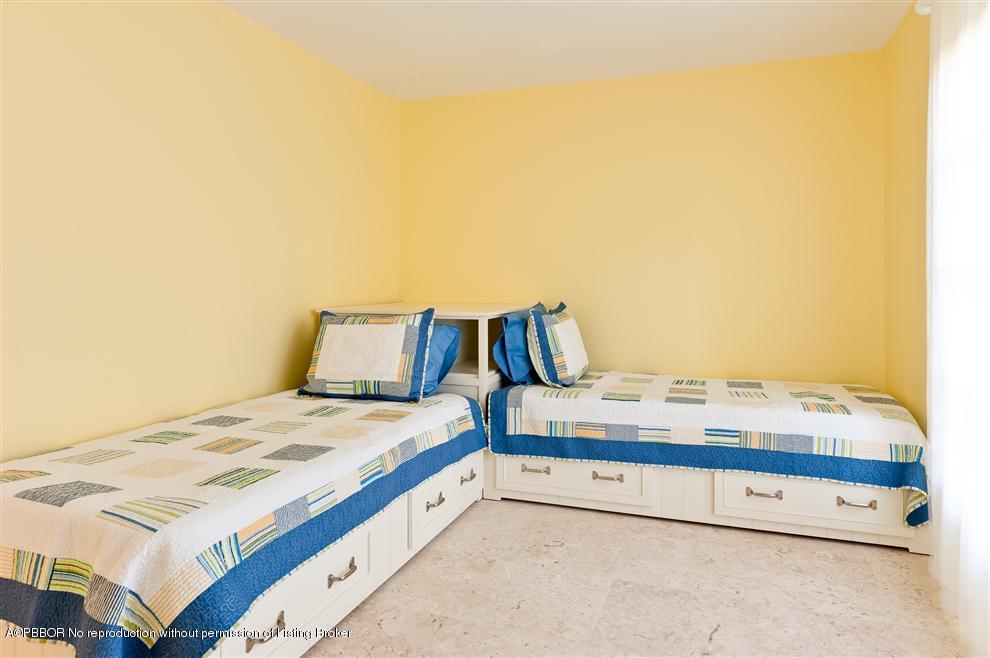 110 Seagate Road Palm Beach, FL 33480 - Photo 7 of 14 a bedroom with a bed and cabinet