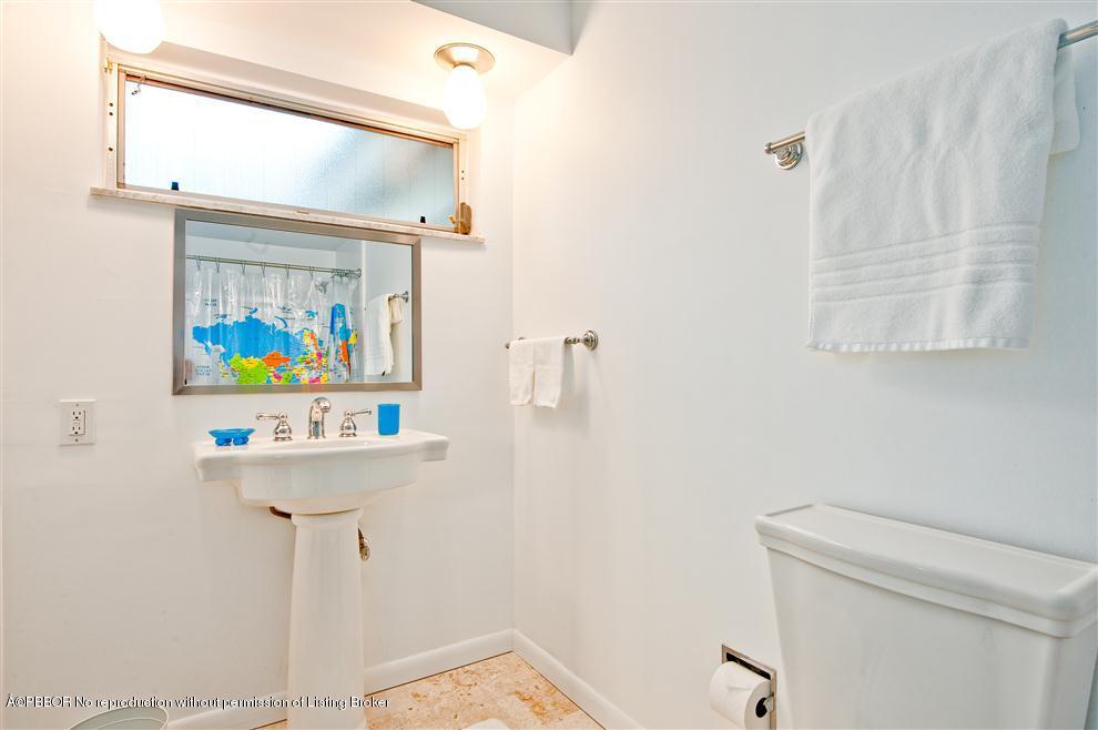 110 Seagate Road Palm Beach, FL 33480 - Photo 8 of 14 a bathroom with a sink a mirror and a toilet