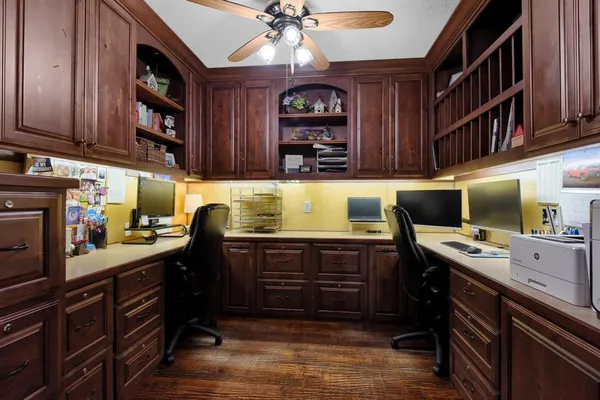 a kitchen that has a lot of counter space and wooden floor