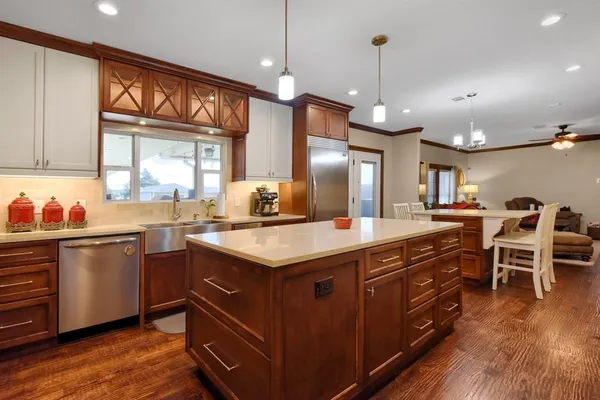 a kitchen with a stove a refrigerator and a sink