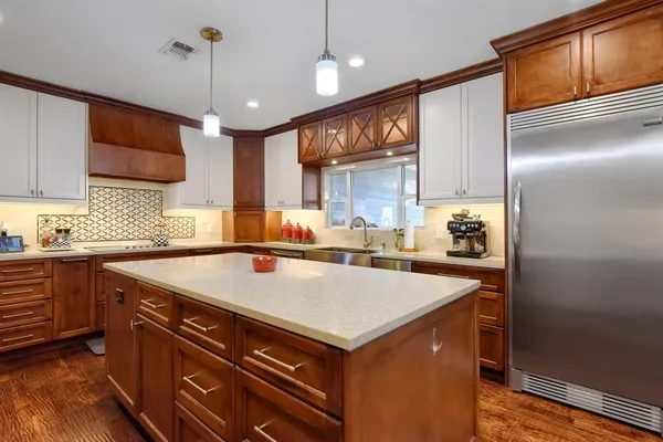 a large kitchen with a table and chairs
