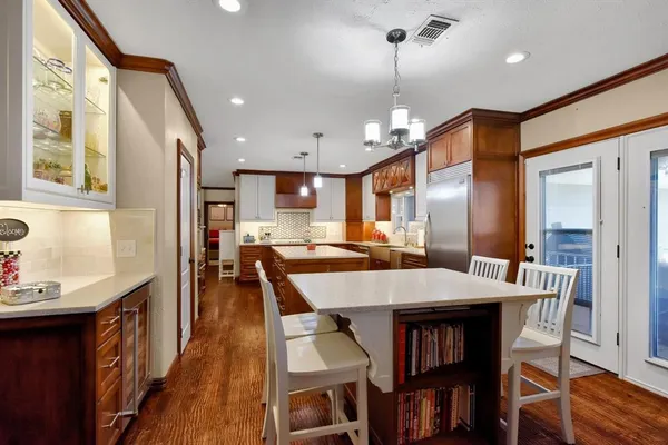 a bedroom with furniture a flat screen tv and a fireplace