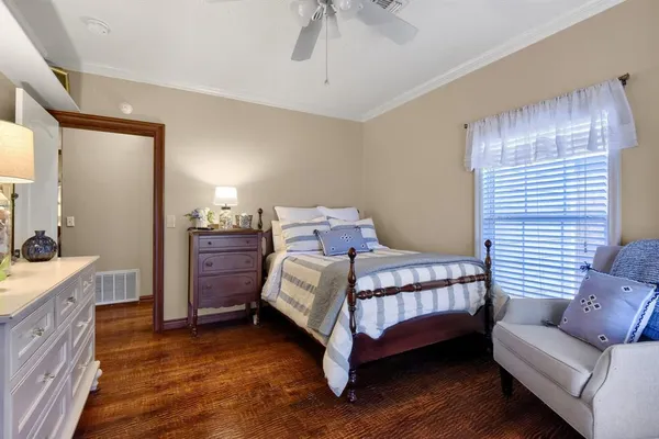 a spacious bedroom with a bed and a chandelier