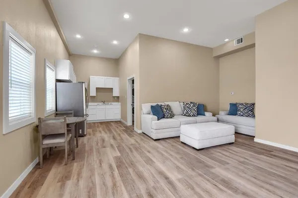 a kitchen with stainless steel appliances white cabinets a sink and a stove