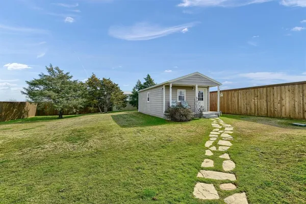a view of a house with a yard and garage