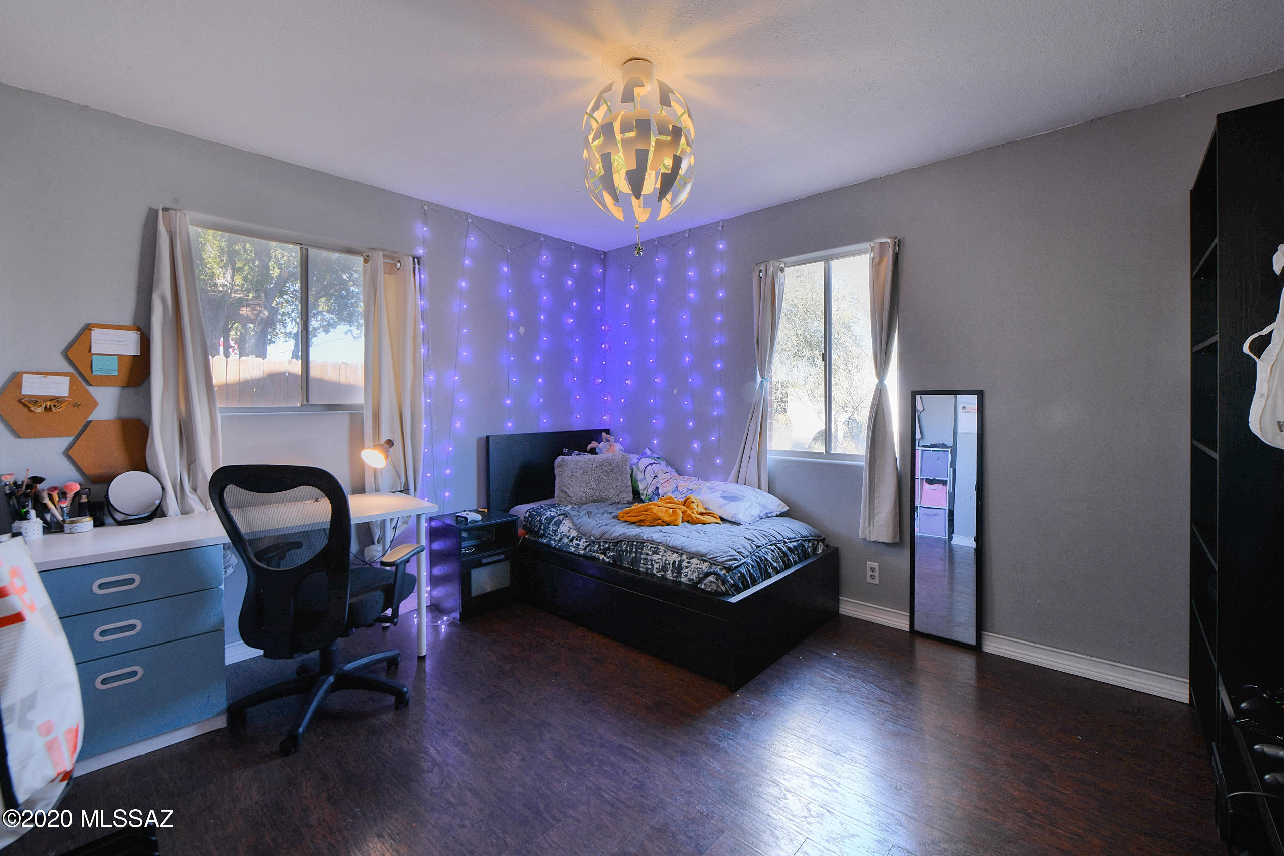 418 East Pastime Road Tucson, AZ 85705 - Photo 8 of 20 a bedroom with a bed chair and a window