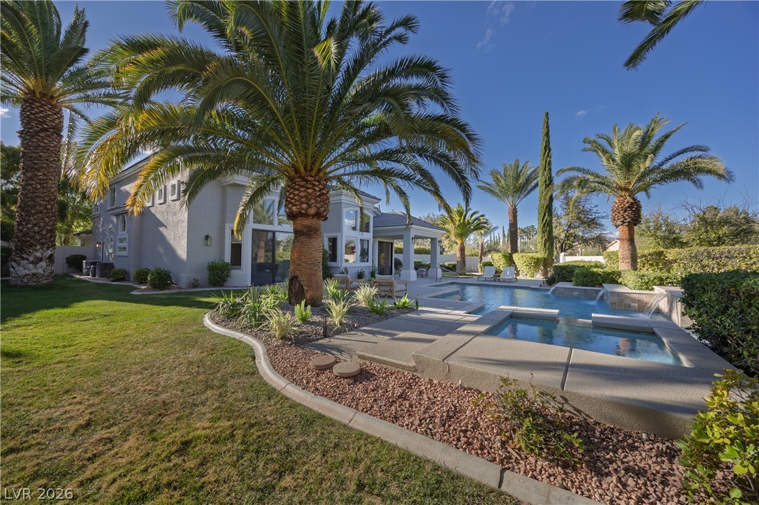 8800 Lusso Las Vegas, NV 89134 - Photo 79 of 85 Combined pool / hot tub with a patio and a lawn