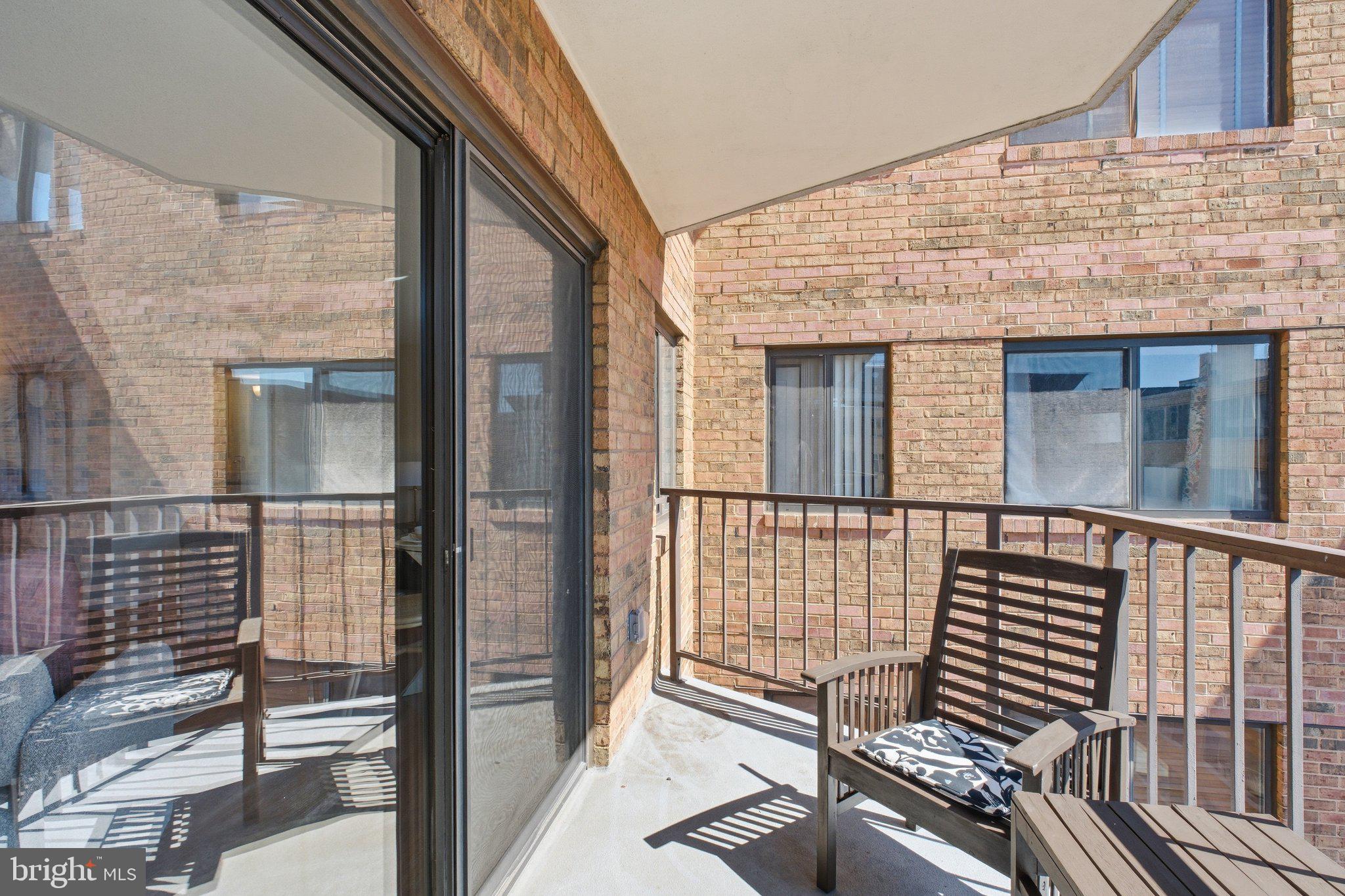 1718 P Street Northwest, Unit 809 Washington, DC 20036 - Photo 17 of 24 Sunny balcony with brick backdrop.