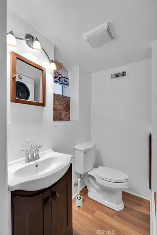 a bathroom with a toilet a sink and mirror