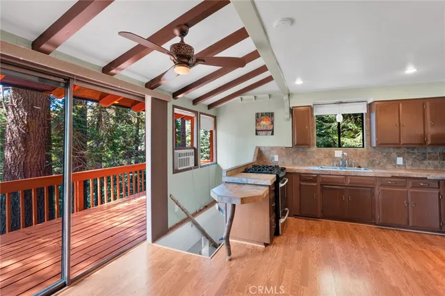 a kitchen with sink cabinets and wooden floor