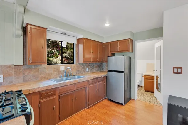 a kitchen with a refrigerator sink and stove