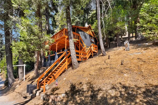 an outdoor space with wooden fence and trees