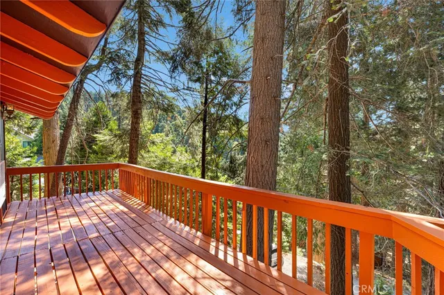 a view of balcony with wooden floor and fence