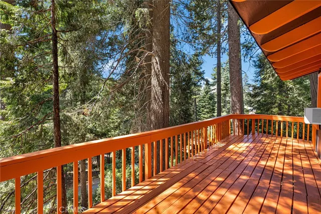 a view of balcony with wooden floor and fence