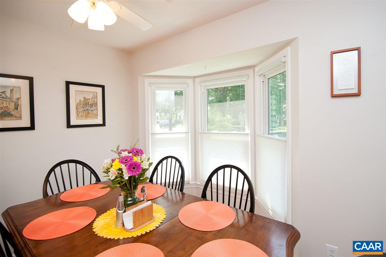 1501 Minor Ridge Court Charlottesville, VA 22901 - Photo 8 of 25 a dining room with wooden floor a potted plant and windows