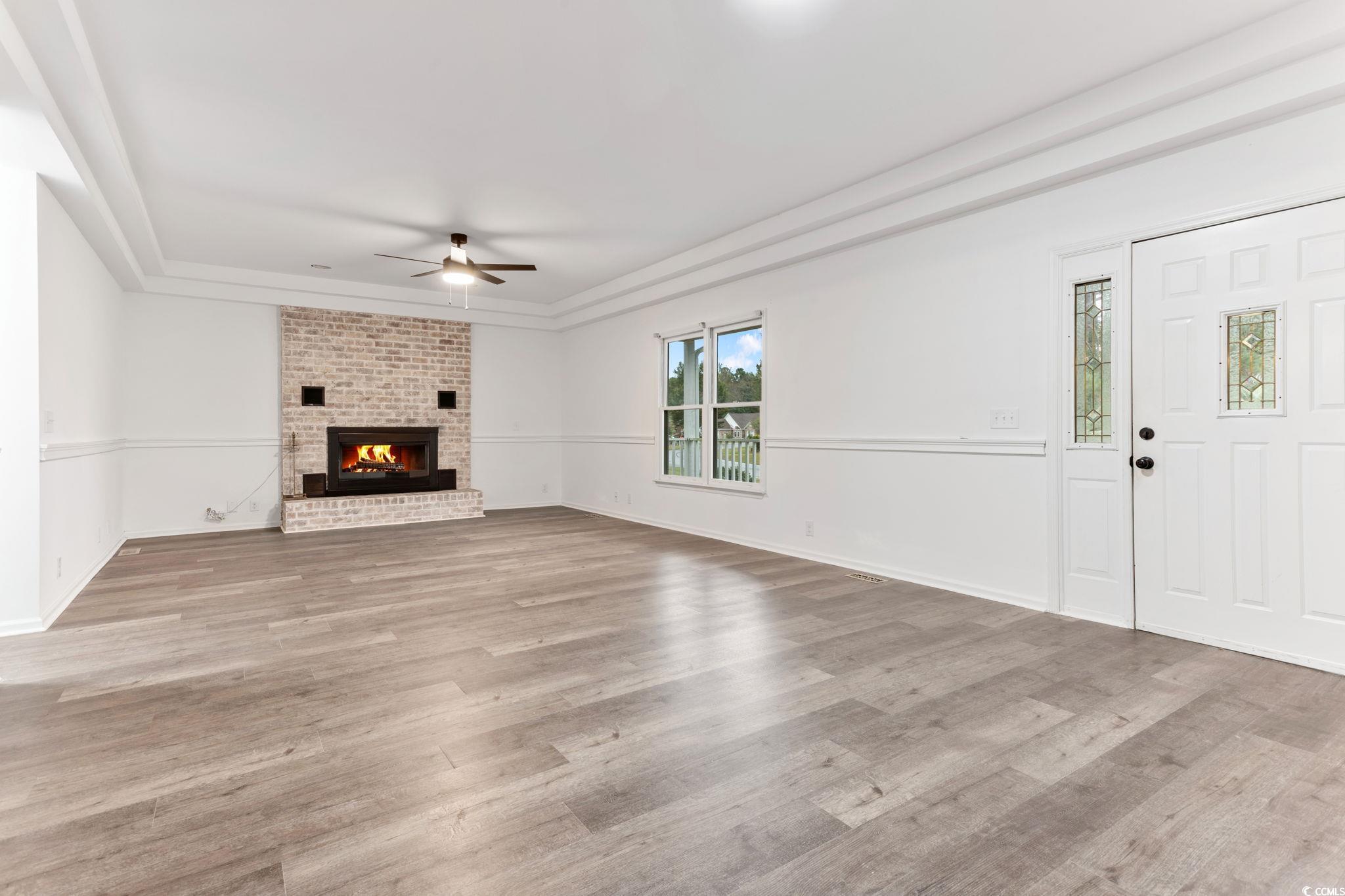 2321 Brick Drive Longs, SC 29568 - Photo 11 of 40 Unfurnished living room featuring light wood finished floors, a fireplace, and ceiling fan
