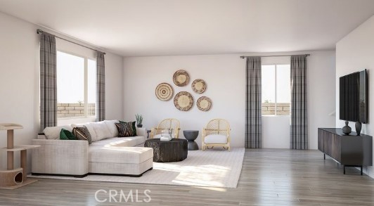 33365 Rusty Court French Valley, CA 92596 - Photo 5 of 9 a living room with couches a coffee table and a flat screen tv with wooden floor