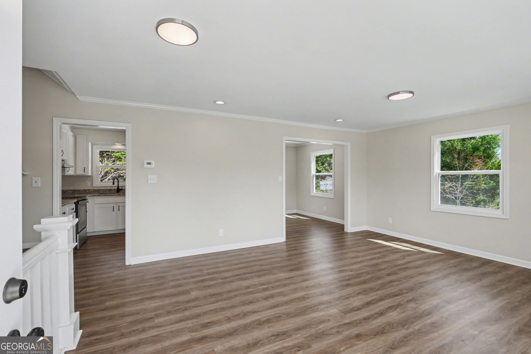 140 Kim Loop Road Demorest, GA 30535 - Photo 5 of 29 an empty room with wooden floor and windows