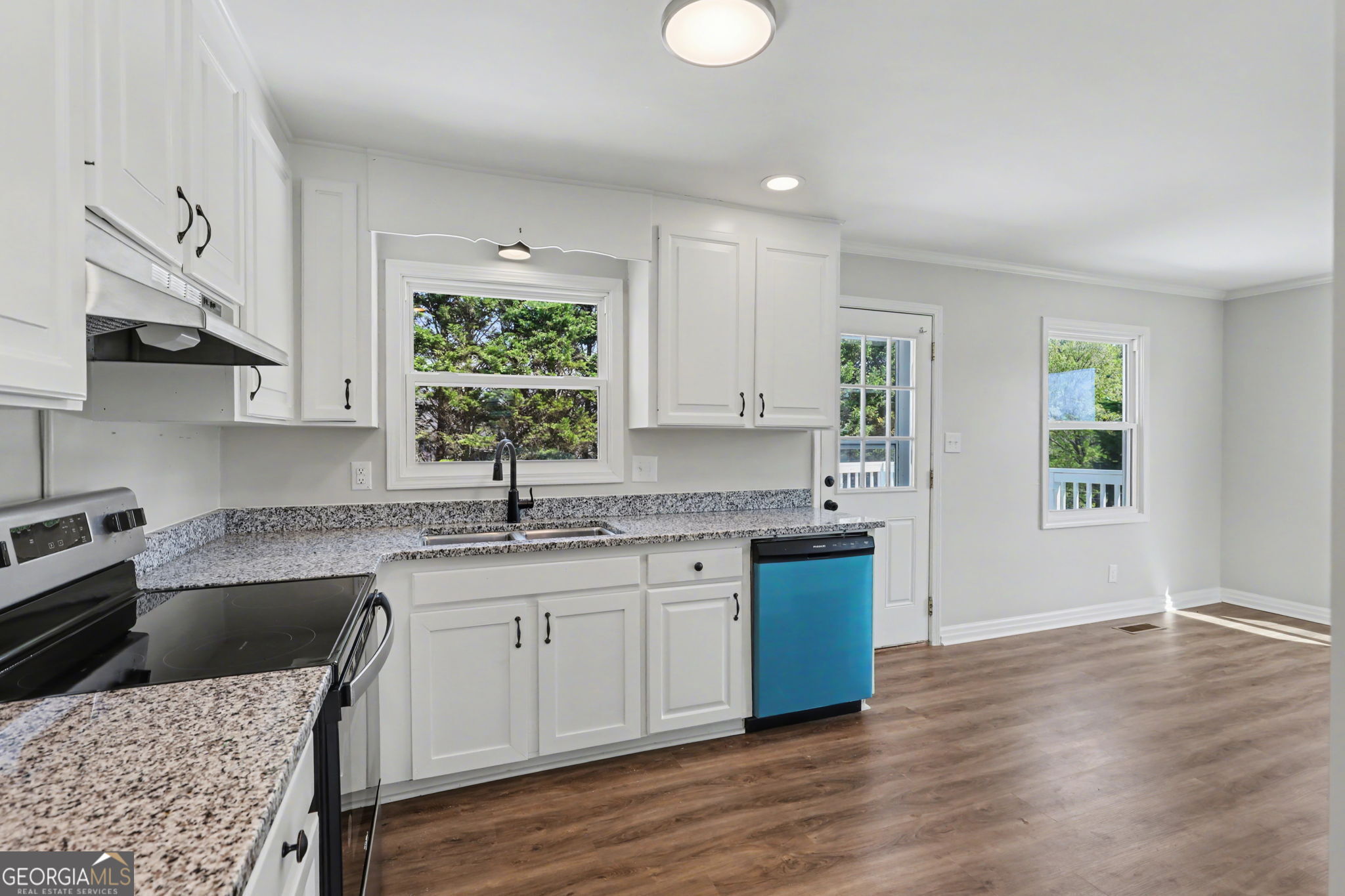 140 Kim Loop Road Demorest, GA 30535 - Photo 9 of 29 a kitchen with granite countertop a sink cabinets and wooden floor