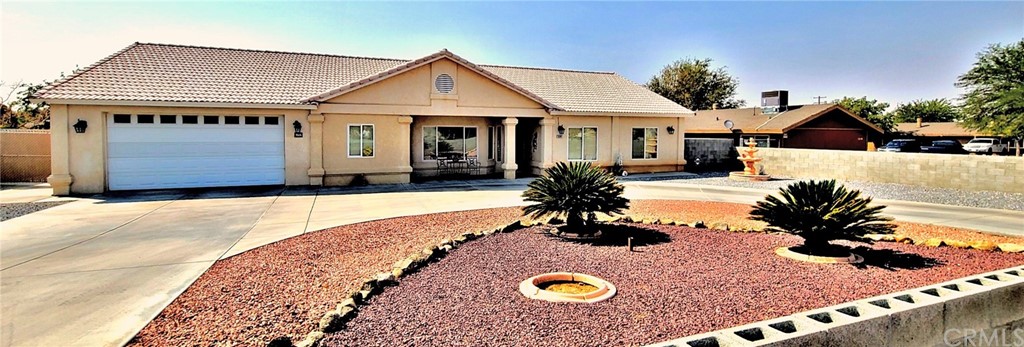 13102 Mohawk Road Apple Valley, CA 92308 - Photo 1 of 1 a front view of a house with yard