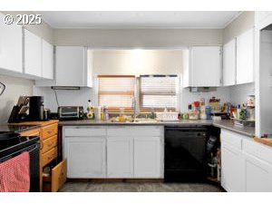 157 North 12th Street, Unit 3 Springfield, OR 97477 - Photo 8 of 28 a kitchen with stainless steel appliances granite countertop a stove a sink a refrigerator and white cabinets