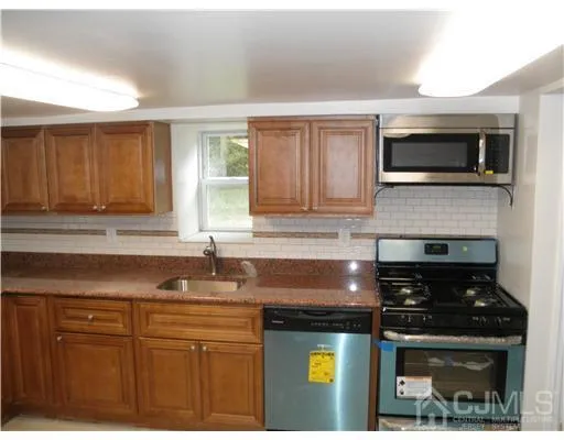 a kitchen with a sink and steel appliances