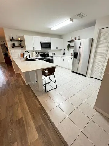 a kitchen with a sink a stove cabinets and a counter top space