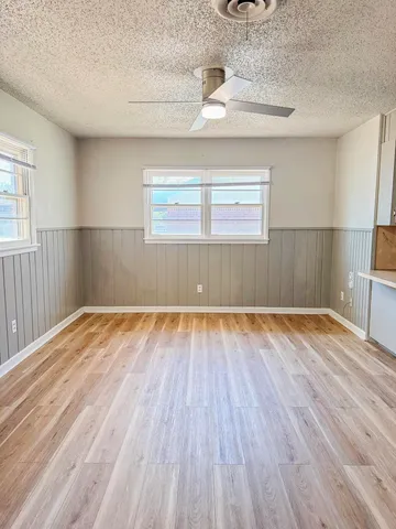 a view of a room with wooden floor and a window