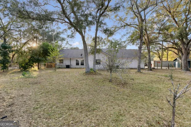 a view of house with a yard
