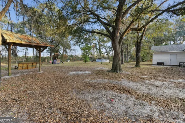 a view of a yard with tree s
