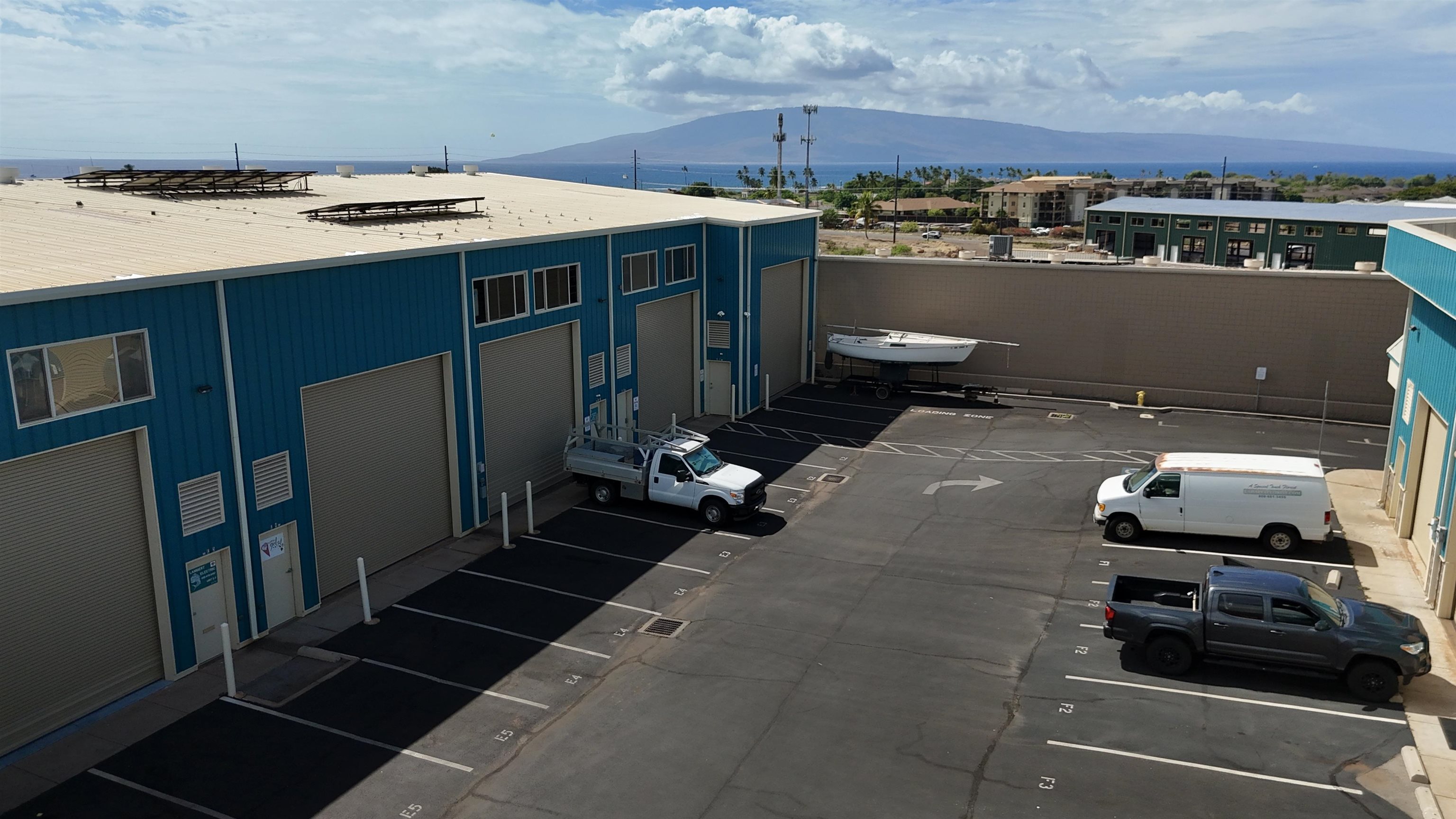 154 Kupuohi Street, Unit E4 Lahaina, HI 96761 - Photo 6 of 9 an aerial view of a house with parking space